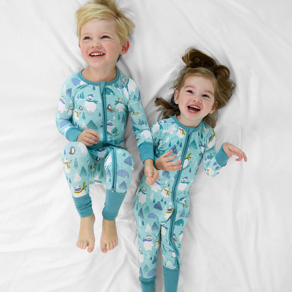 two children on a bed wearing matching Yeti Snow Day zippies