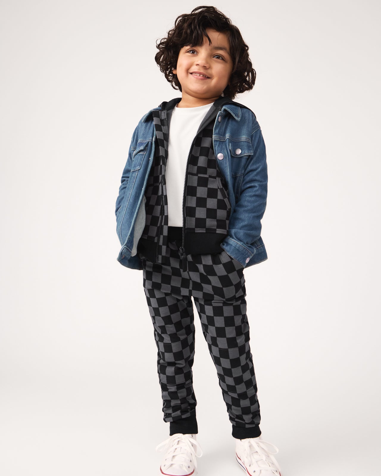 Boy wearing the Monochrome Checks Jogger and Hoodie Set with a denim jacket