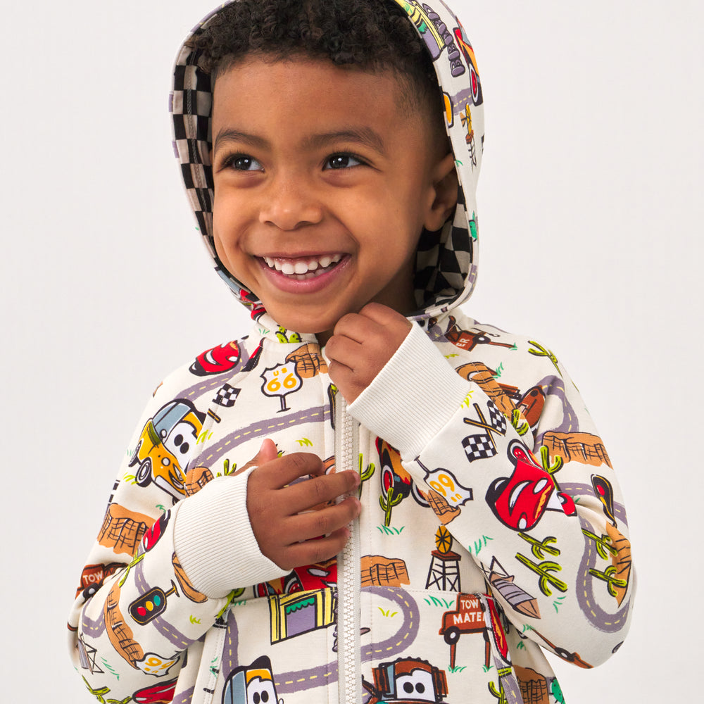 Alternate close up image of a child wearing a Radiator Springs zip hoodie