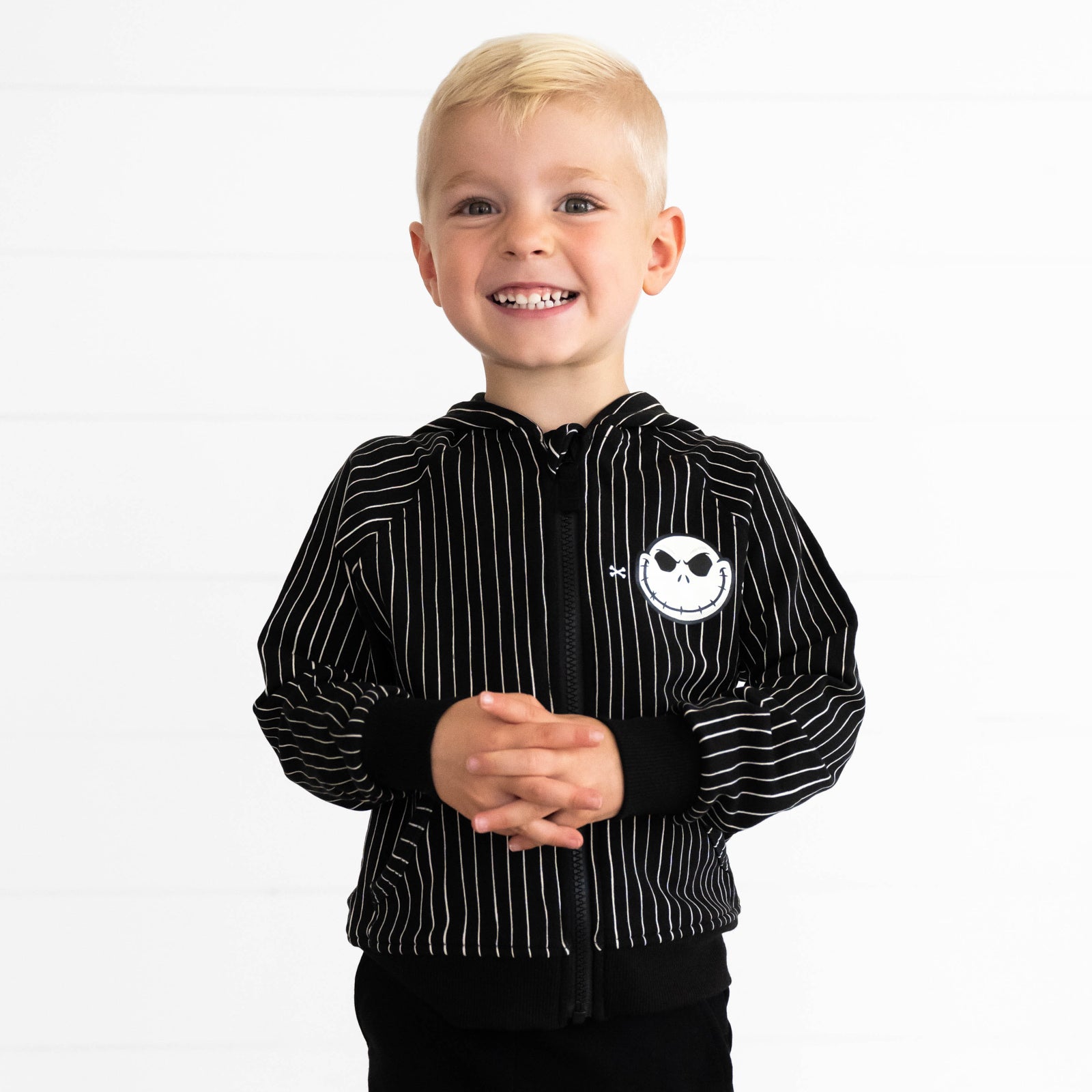 Boy smiling while wearing the Disney Jack Skellington Zip Hoodie