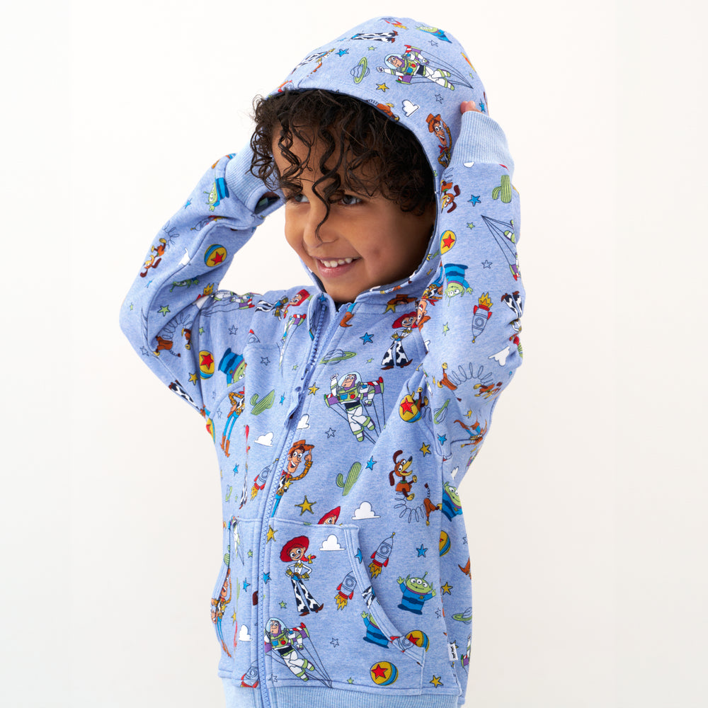 Click to see full screen - Close up image of a child wearing a Disney Pixar Toy Story Pals zip hoodie with the hood up