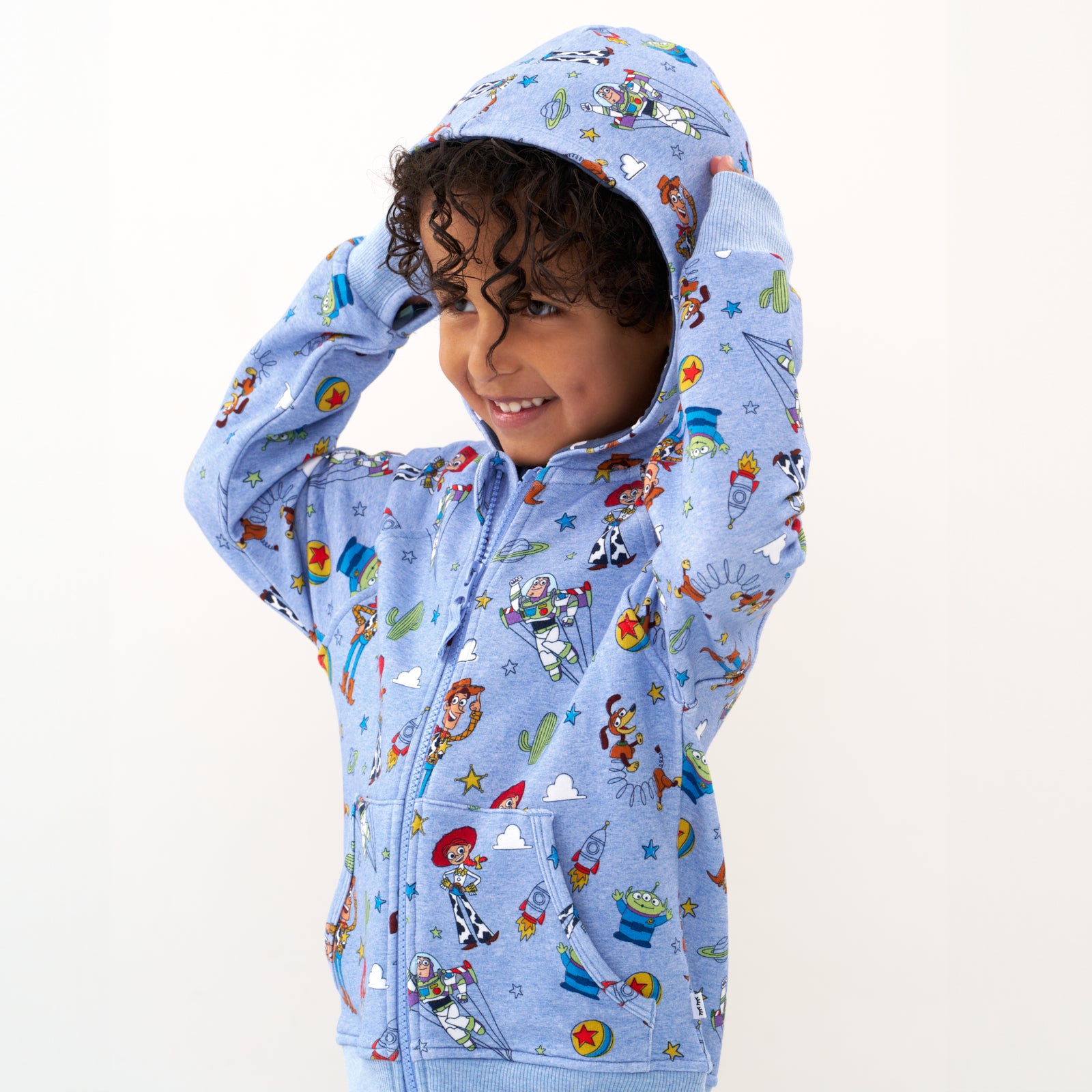 Close up image of a child wearing a Disney Pixar Toy Story Pals zip hoodie with the hood up