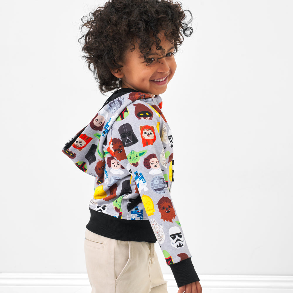 Side view image of a child wearing a Legends of the Galaxy zip hoodie with matching Play bottoms