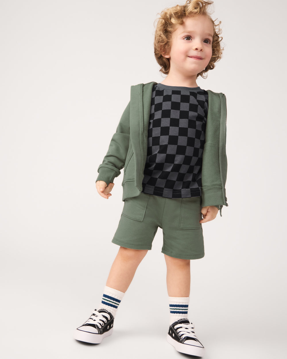 Boy wearing the Moss Shorts with a monochrome checks tee