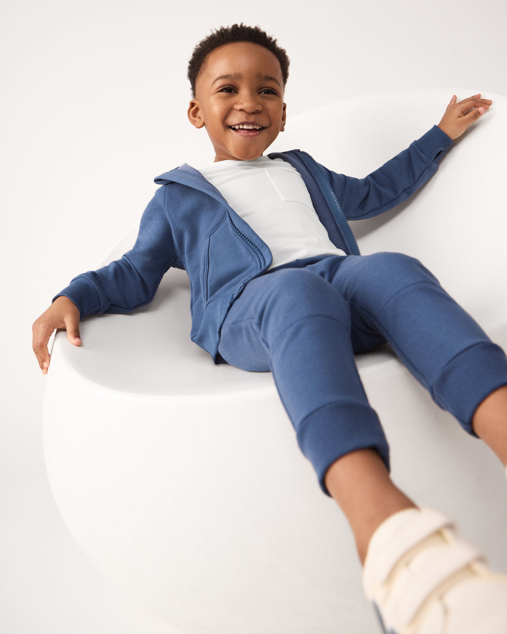 Boy wearing the Vintage Navy Zip Hoodie and jogger sweatpants