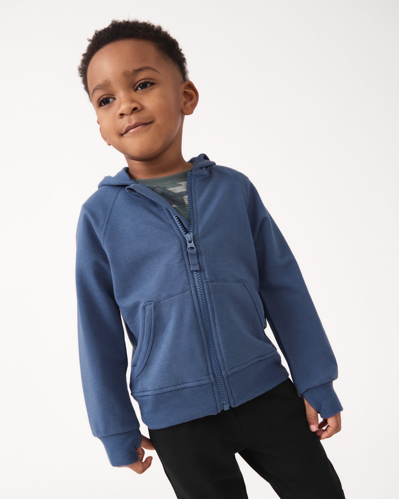 Boy wearing the Vintage Navy Zip Hoodie with black joggers