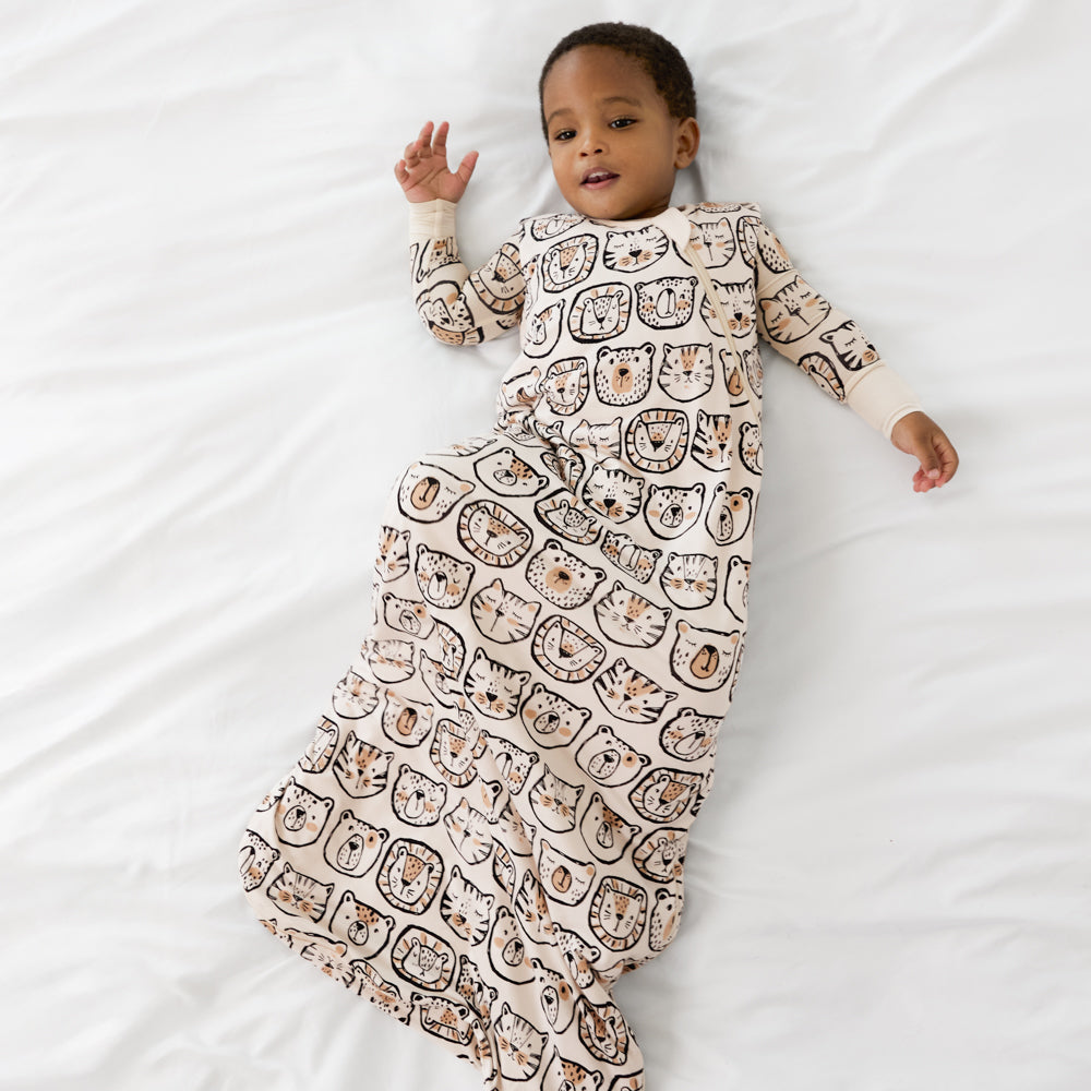 Image of a child wearing a Lions, Tigers, and Bears sleepy bag