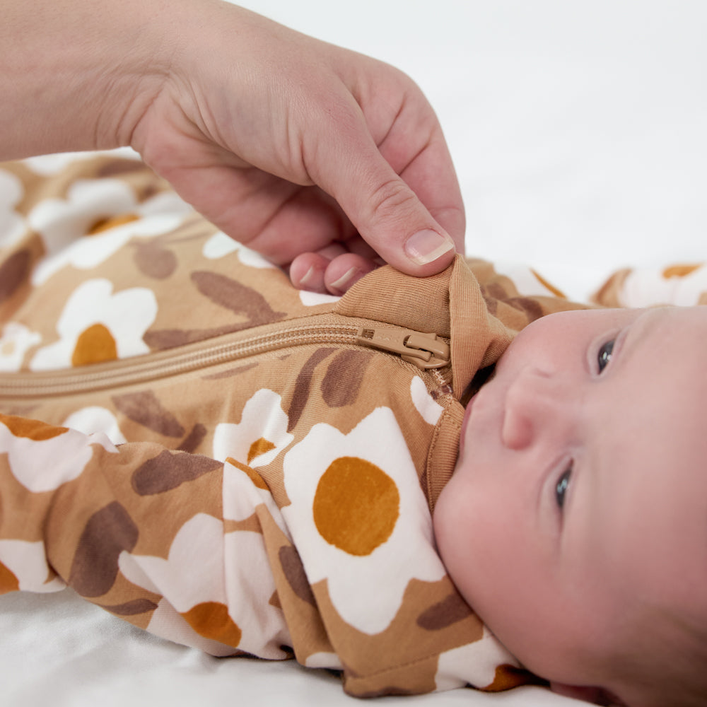 Close up image of a zipper on a child wearing a Daisy Daydream sleepy bag