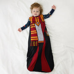 Child laying on a bed wearing a Harry Potter™ Gryffindor™ Robe Costume Sleepy Bag