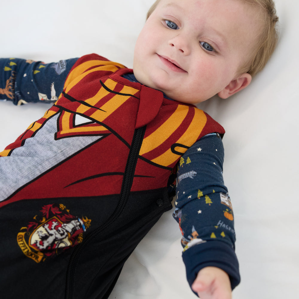 Close up image of a child laying on a bed wearing a Harry Potter™ Gryffindor™ Robe Costume Sleepy Bag