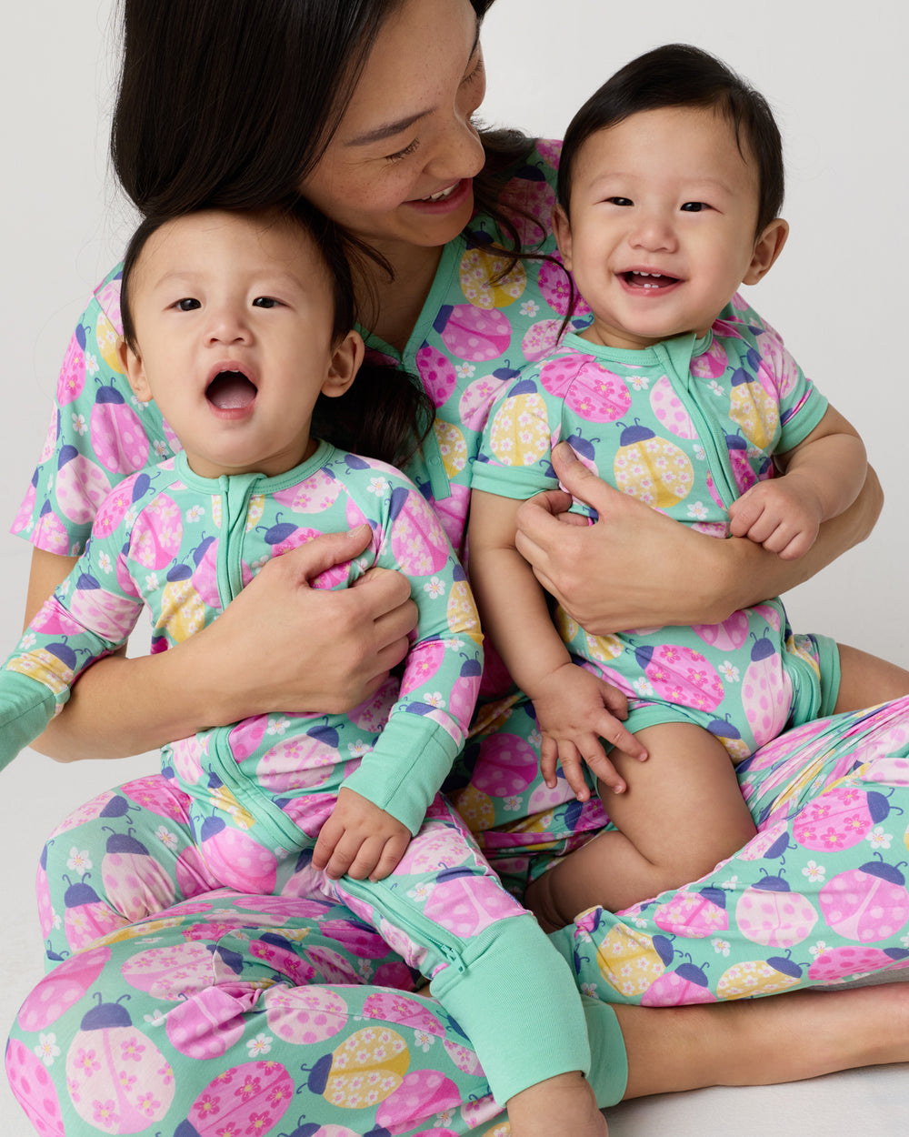 Mother and two children wearing matching Ladybug Meadow pajamas