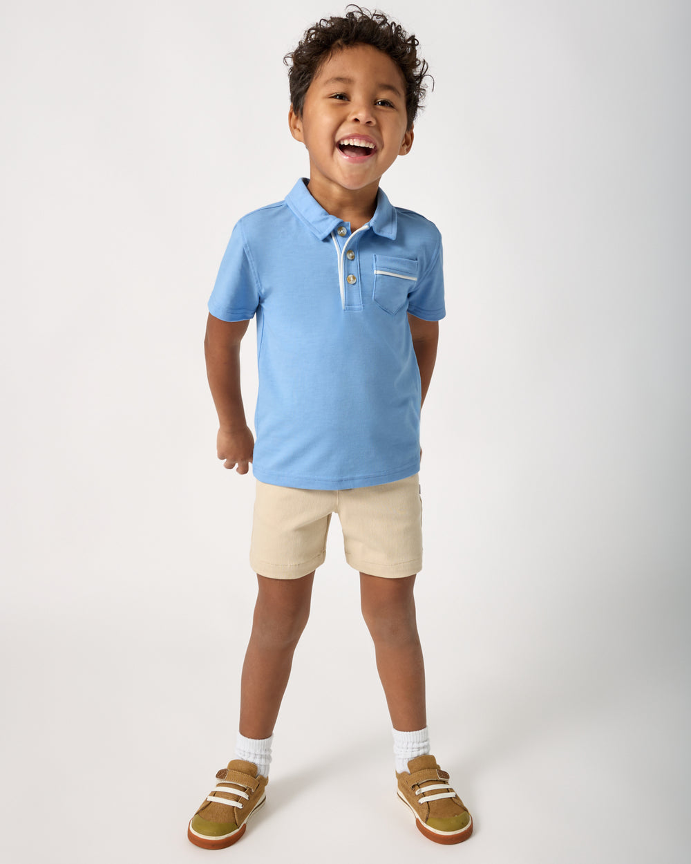 Boy wearing the Lakeside Blue Polo Shirt with chino shorts