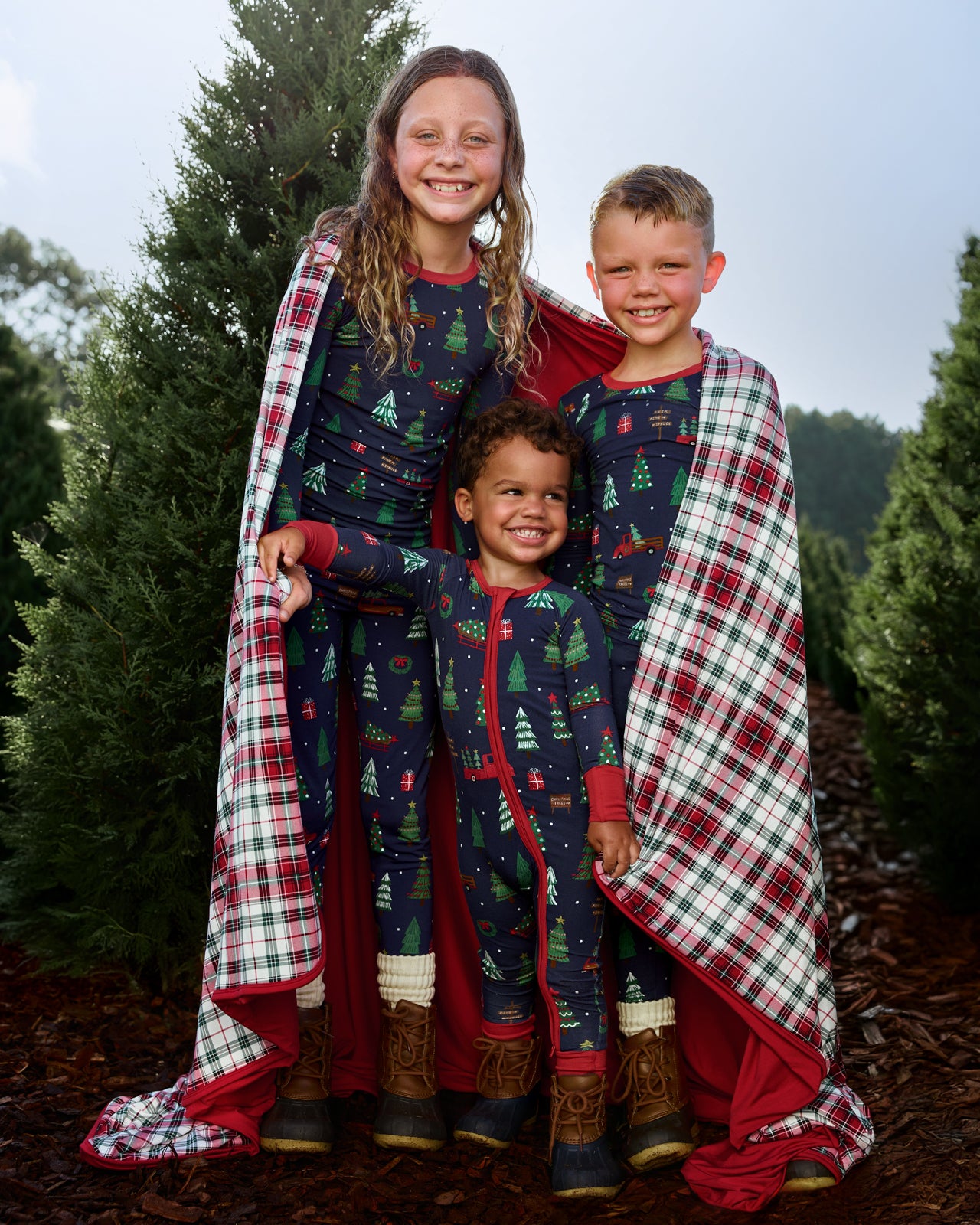 Three kids wearing matchig Navy Tree Traffic pajamas