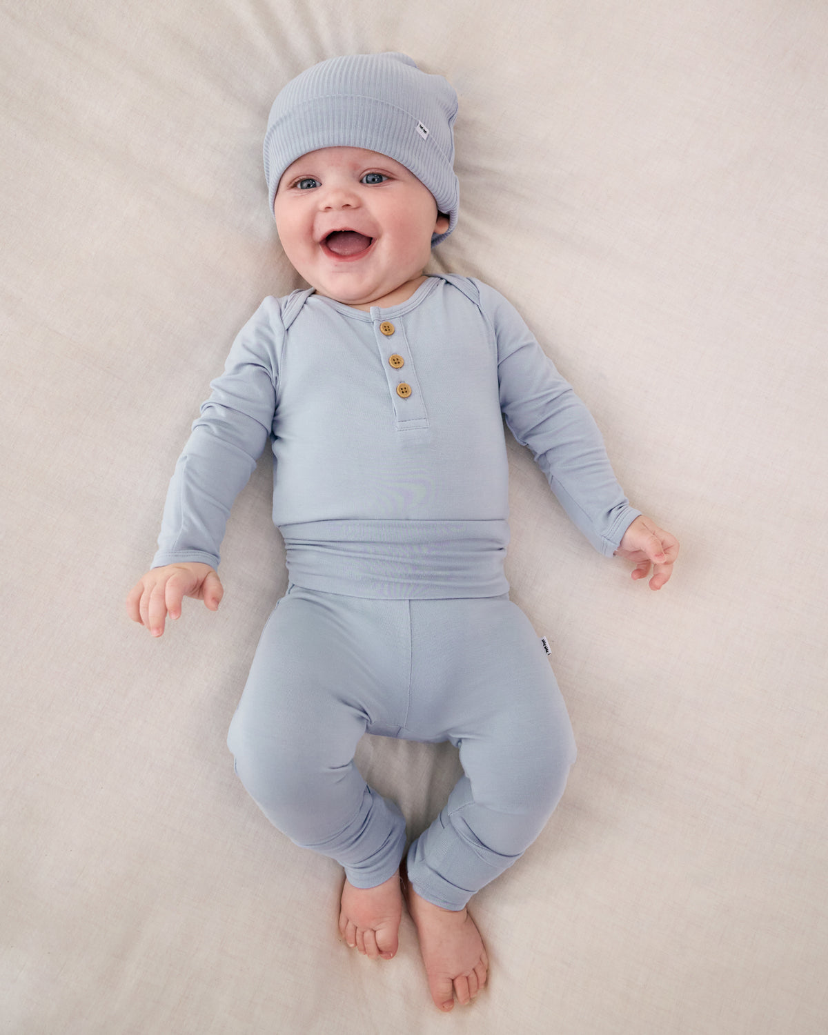 Aerial view of baby wearing the Light Fog Fold-Over Legging