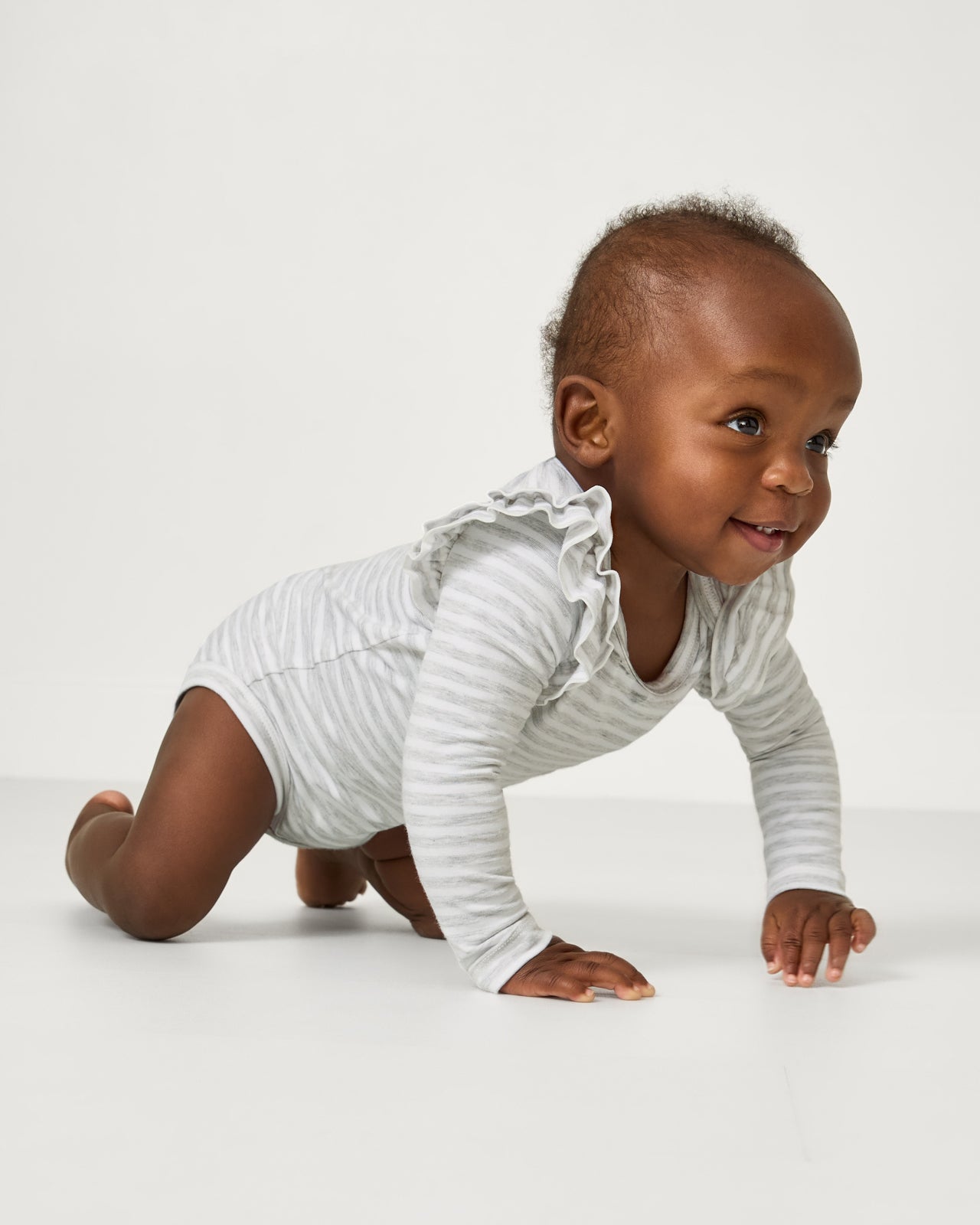 Crawling child wearing the Light Heather Gray Stripe Flutter Bodysuit