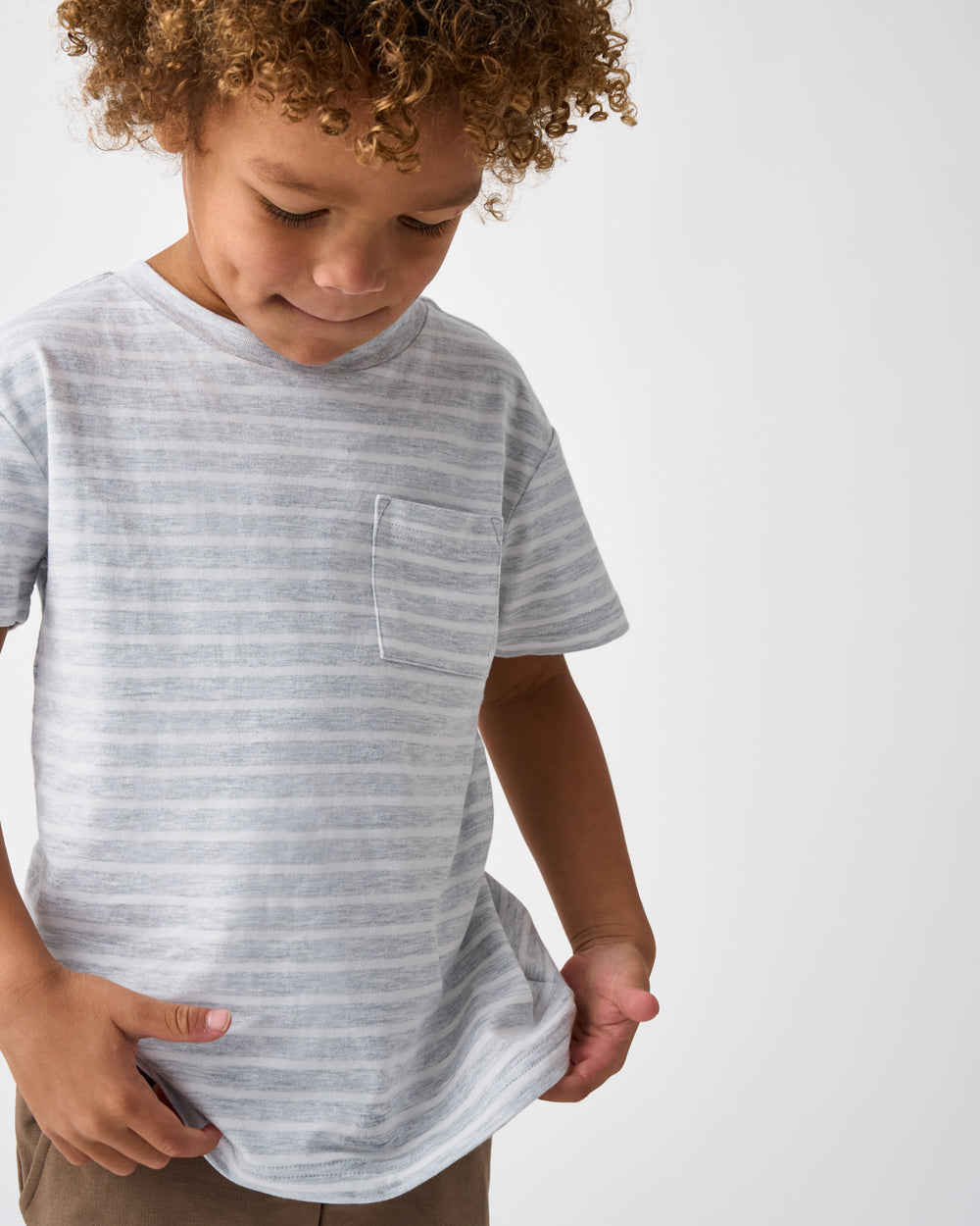 Close up of child wearing the Light Heather Gray Stripes Relaxed Pocket Tee