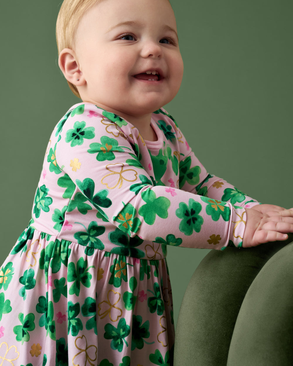 Close up of baby wearing the Clover Cuties Twirl Dress with Bodysuit