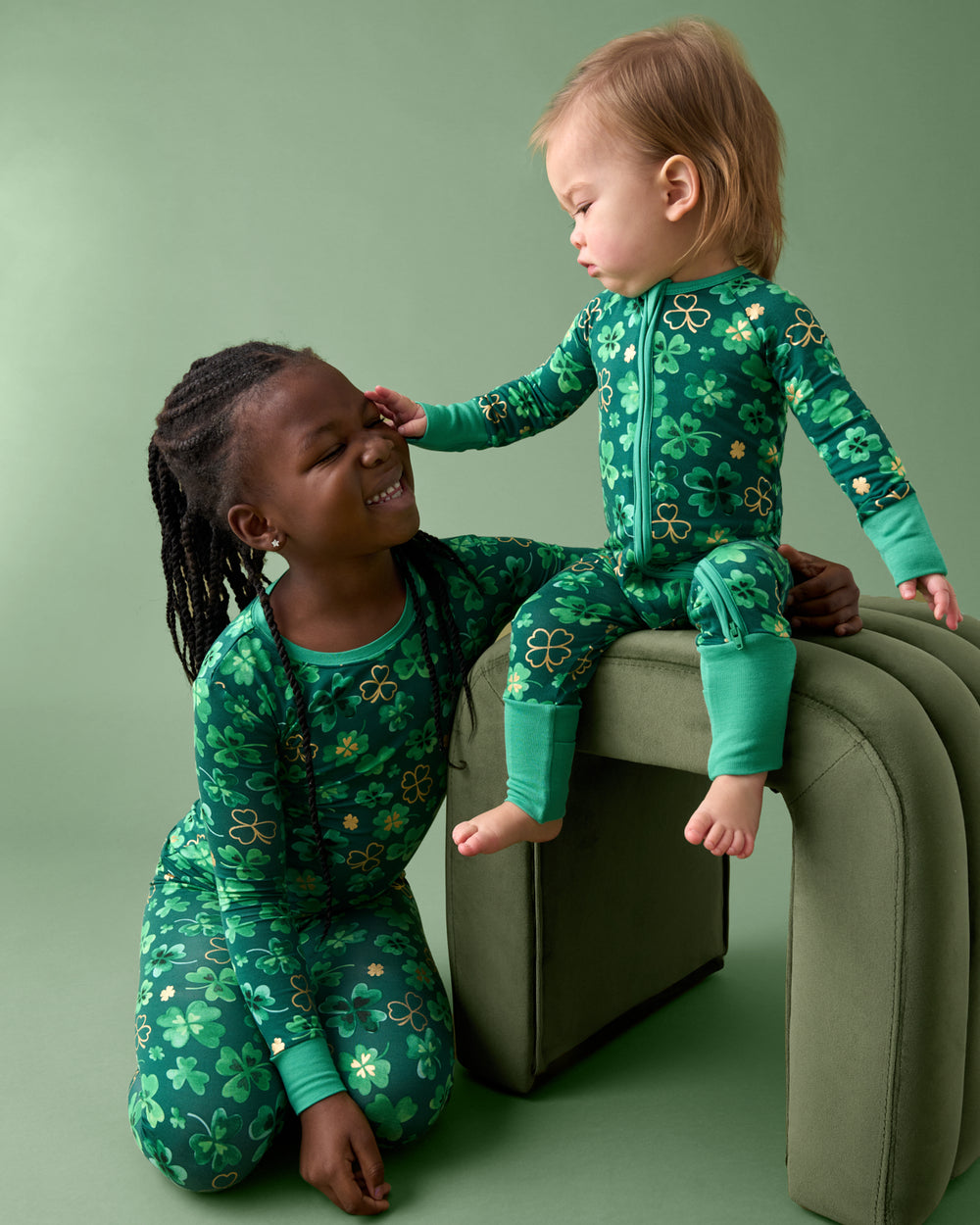 Two children wearing matching Clover Cuties pajamas