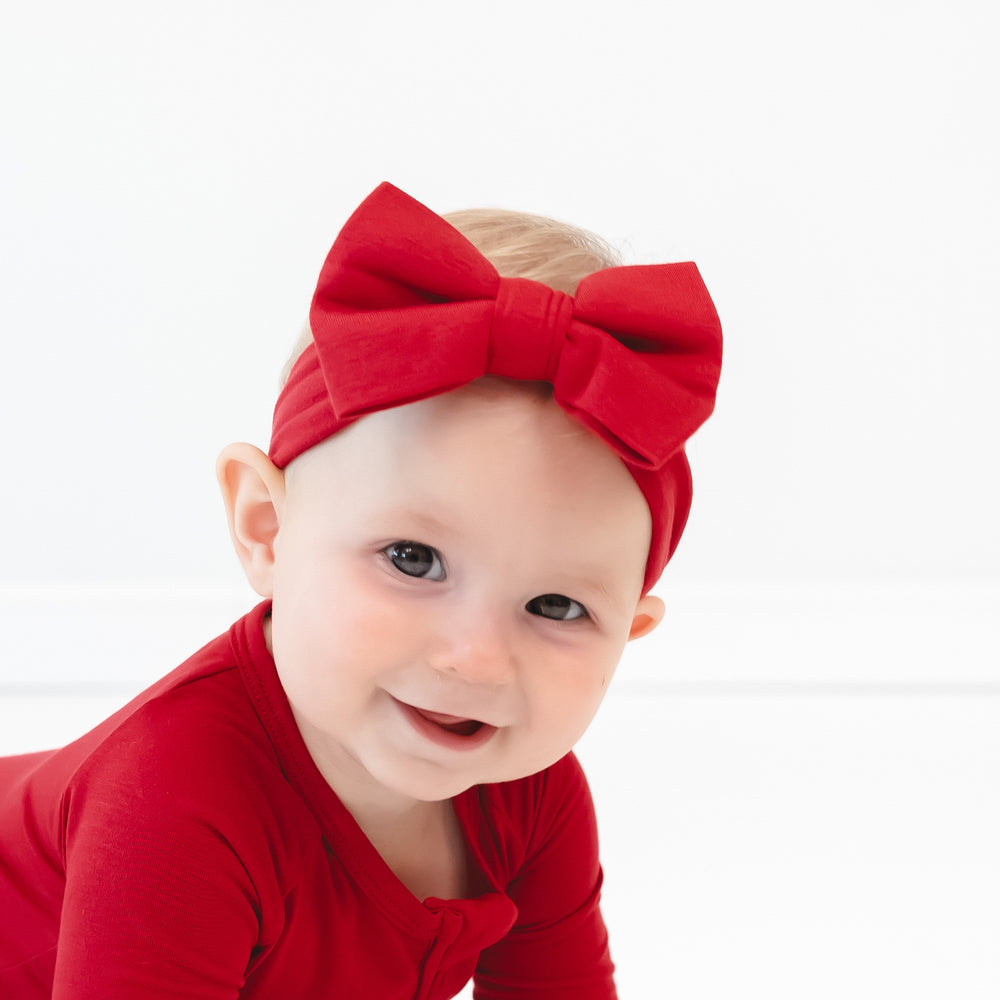 Close up image of baby crawling while wearing the Holiday Red Luxe Bow Headband