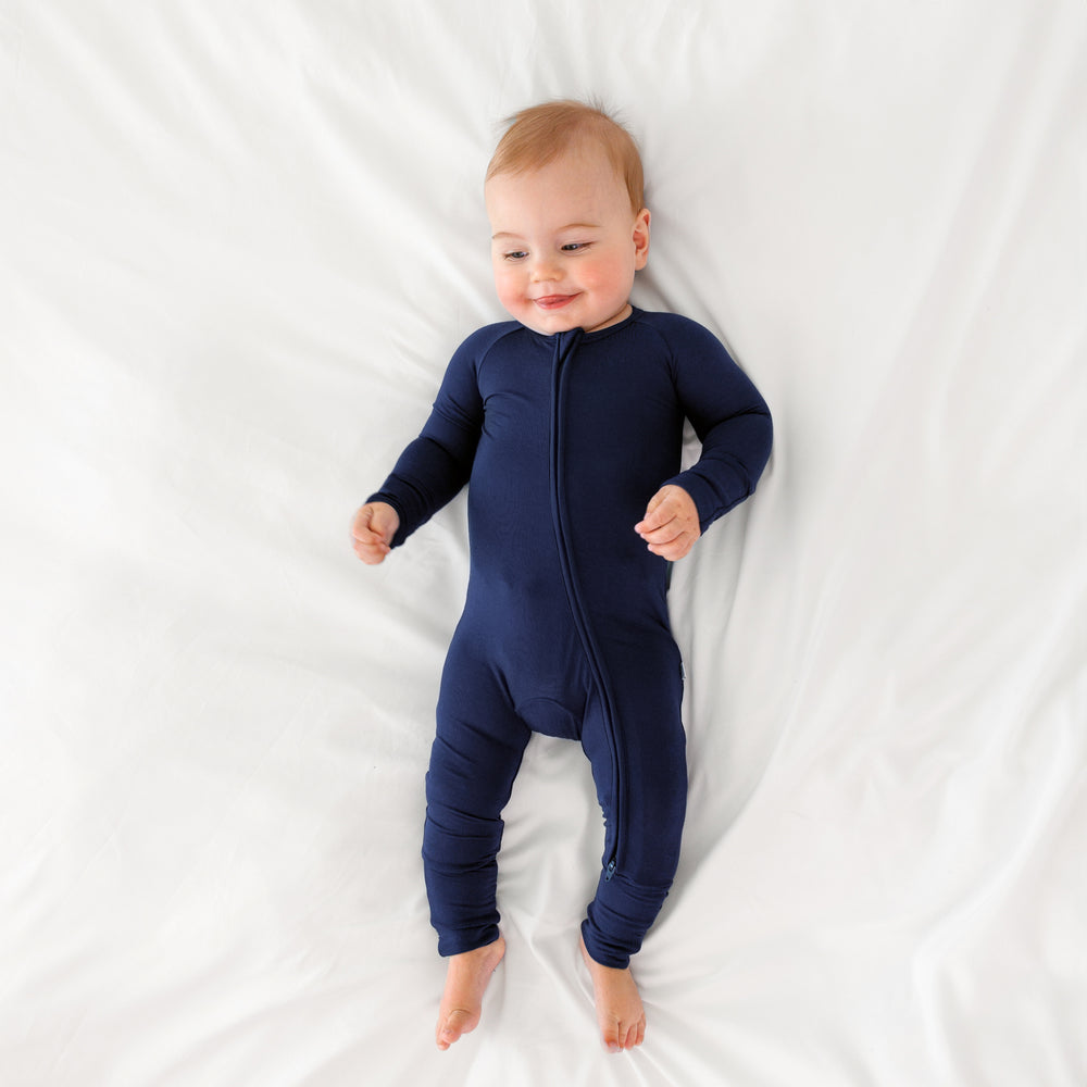 Top view image of baby laying down while wearing the Classic Navy Zippy