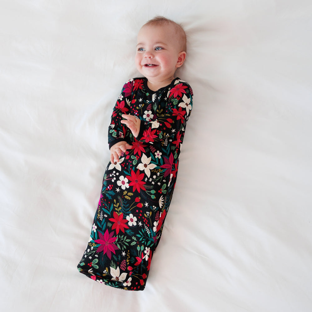 Top view image of a baby laying down while in the Berry Merry Infant Gown