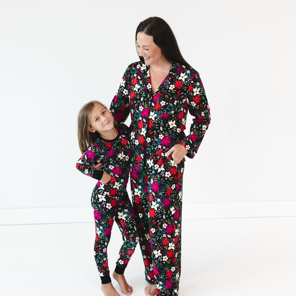 Girl on the left is wearing the Berry Merry Two-piece Pajama Set and mother on right is wearing the Berry Merry Women's Long Sleeve Pajama Set