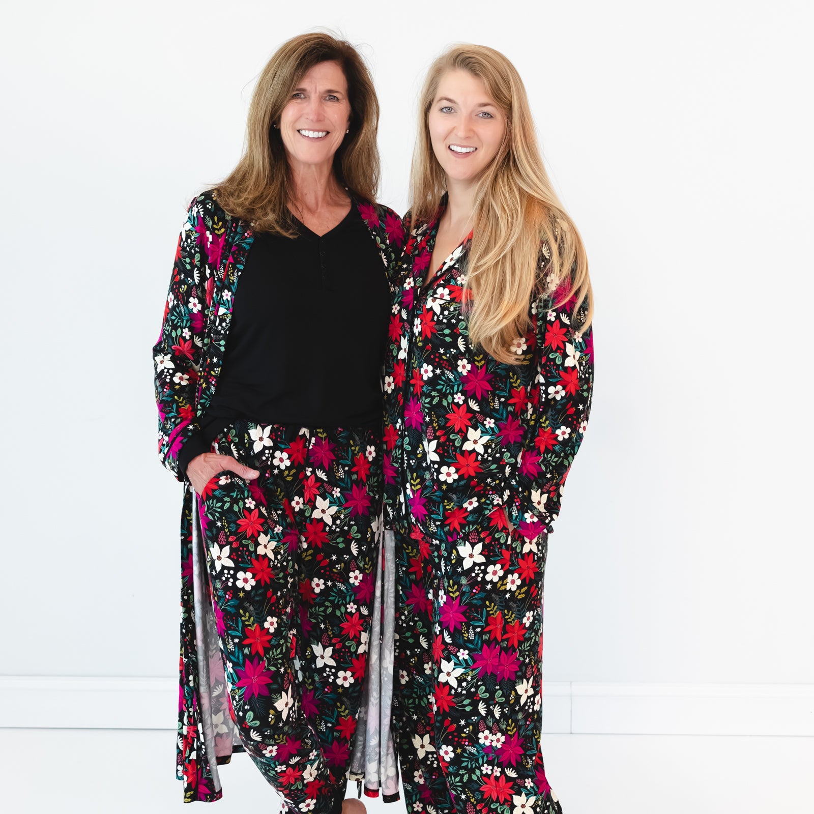 Female on the left is in the Berry Merry Women's Robe and Berry Merry Women's Pajama Pants and female model on the right is in the Berry Merry Two-piece Women's Pajama Set