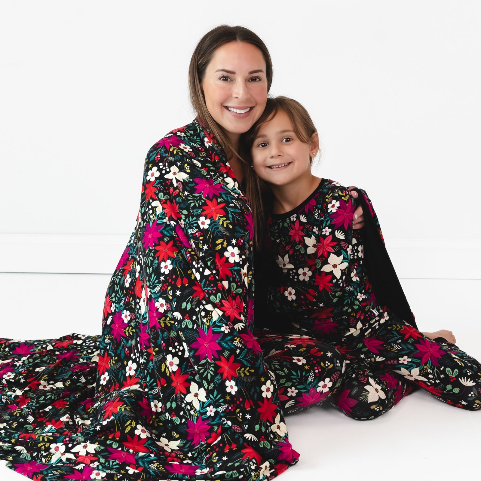 Mother and daughter wrapped in the Berry Merry Oversized Cloud Blanket®