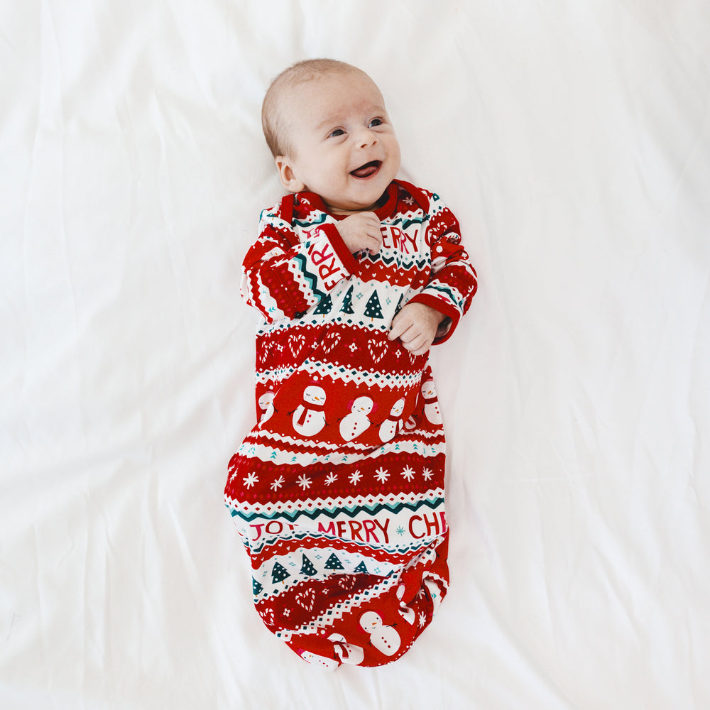 Infant laying on a blanket wearing a Festive Fair Isle Infant Gown