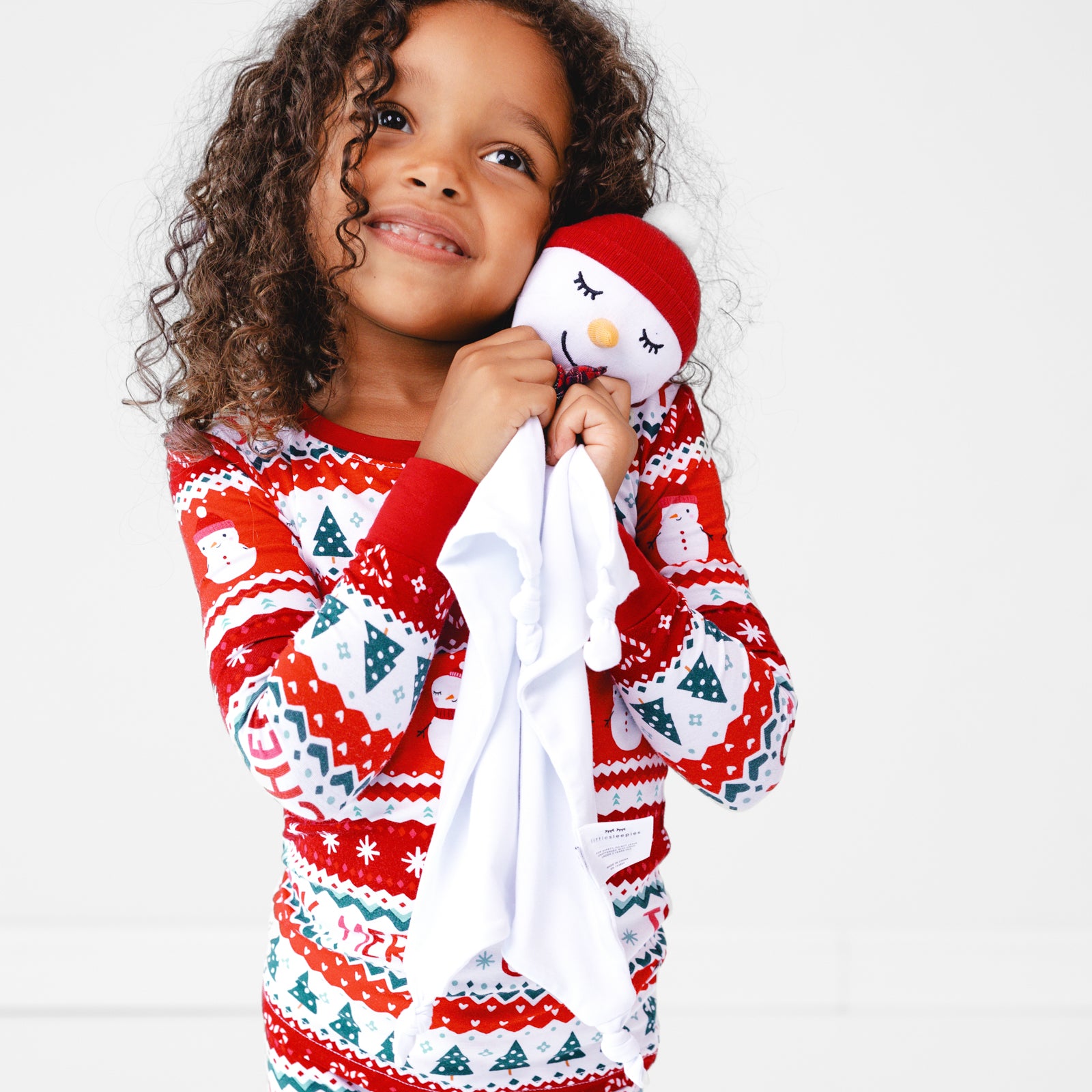 Image of a child cuddling a Sammy the Snowman Sleepyhead Lovey