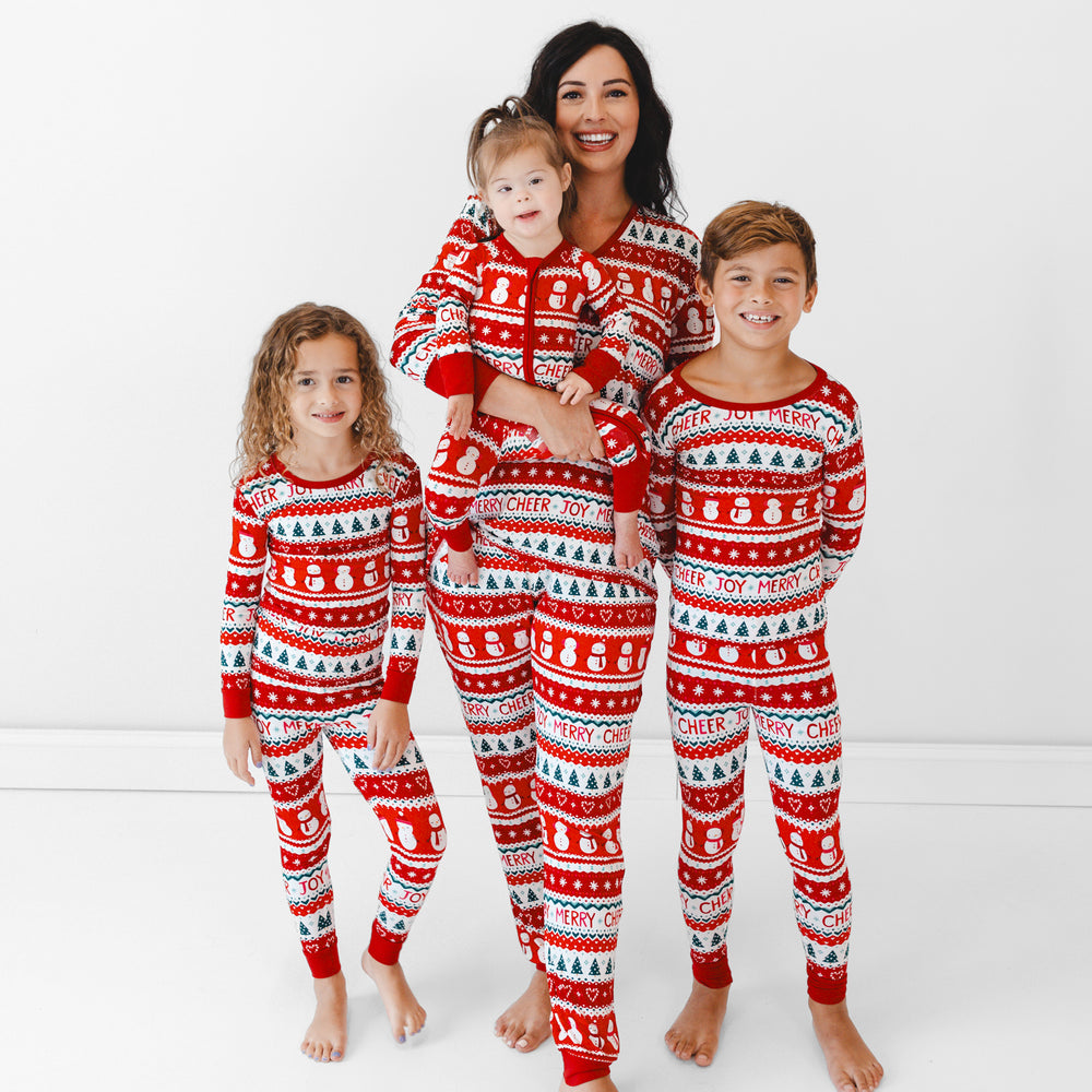 Family of four wearing matching Festive Fair Isle pajamas