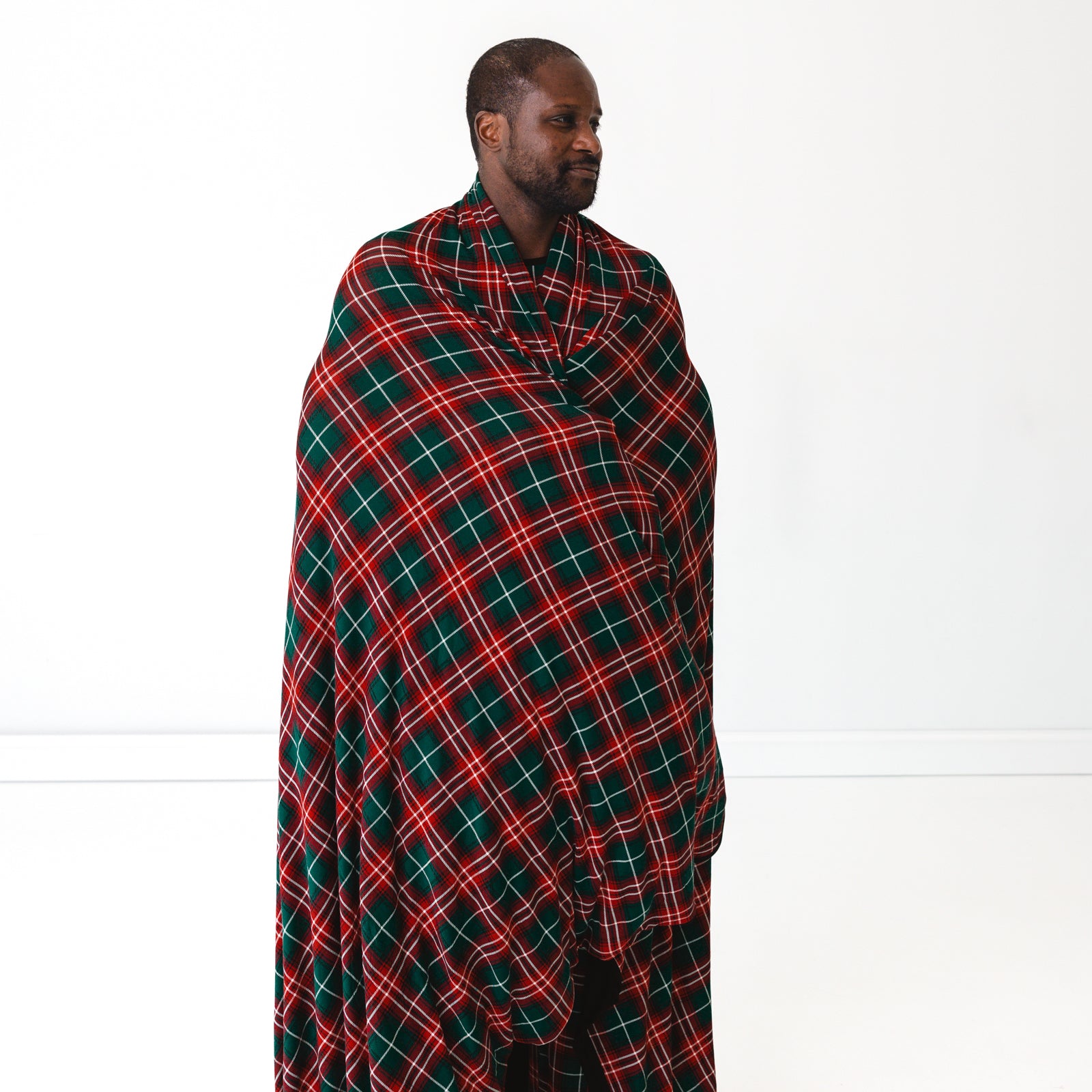 Man wrapped up in a Fireside Plaid Oversized Cloud Blanket®