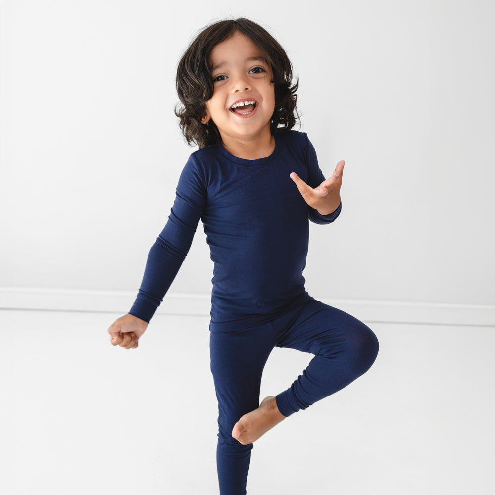 Alternative image of child posing while wearing the Classic Navy Two-Piece Pajama Set