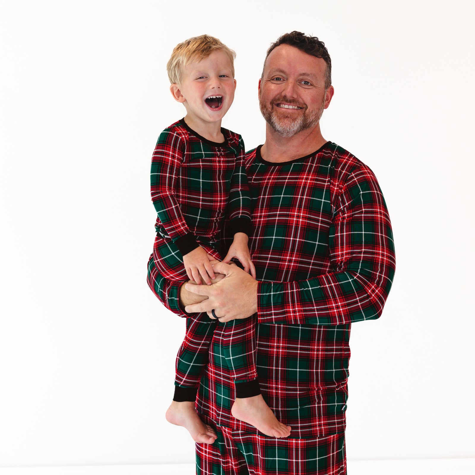 Father and son wearing matching Fireside Plaid pajamas