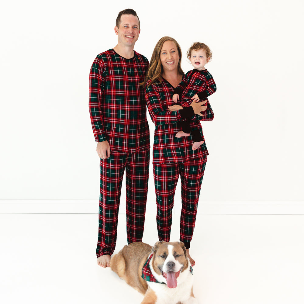 Family of three and a dog wearing matching Fireside Plaid pajamas