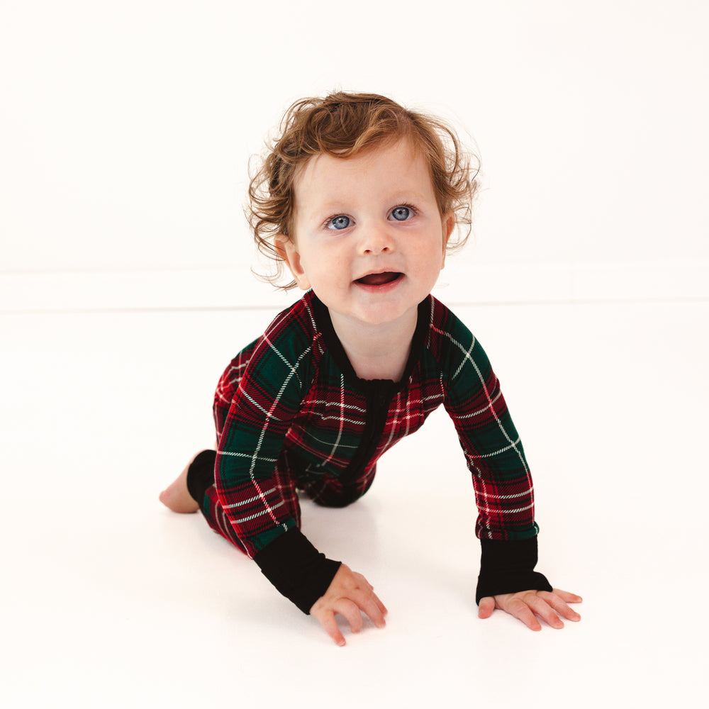 Child crawling on the ground wearing a Fireside Plaid Zippy