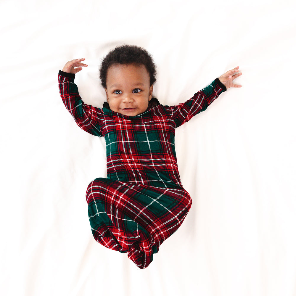 Infant laying on a blanket wearing a Fireside Plaid Infant Gown