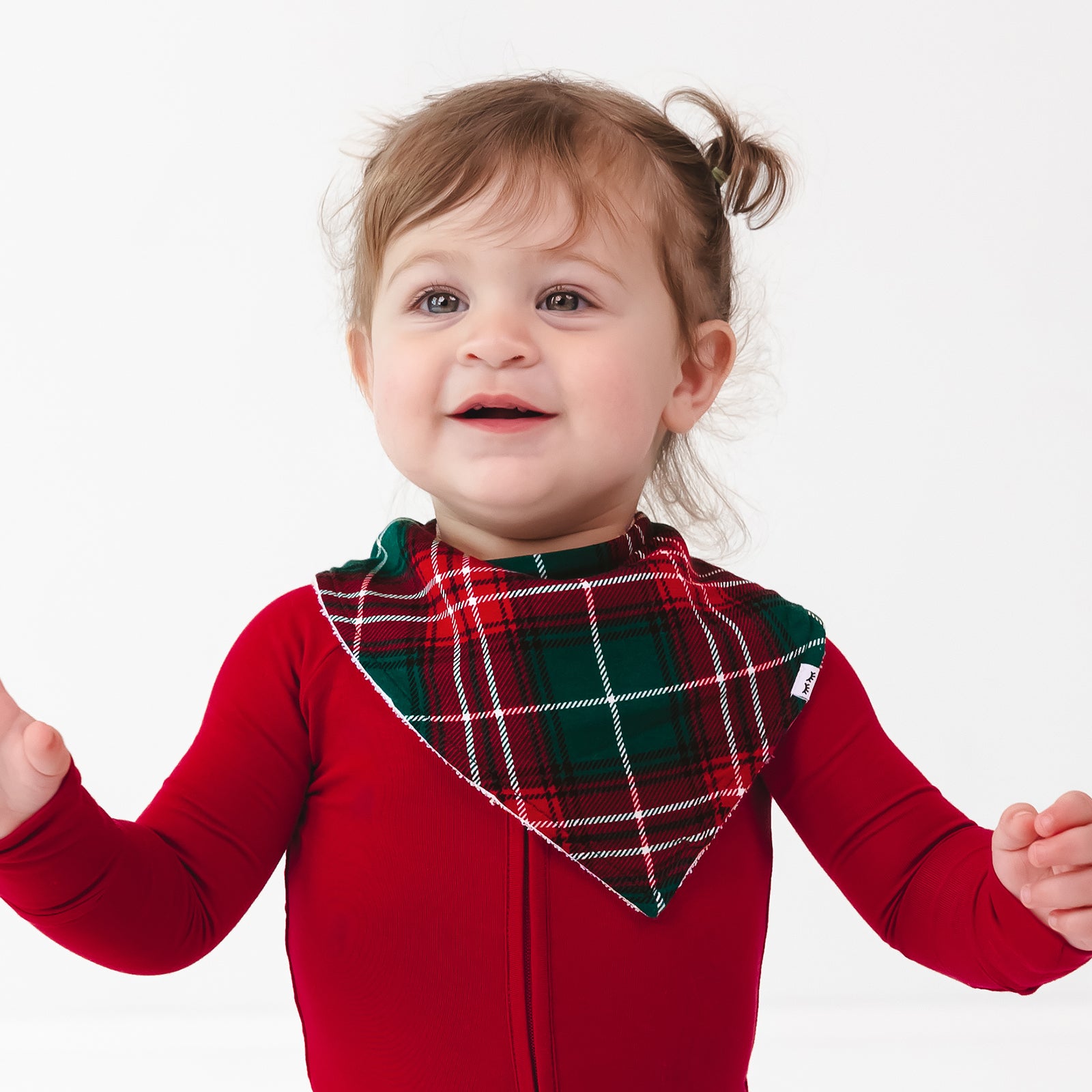 Child wearing a Fireside Plaid Bandana Bib and Holiday Red Zippy