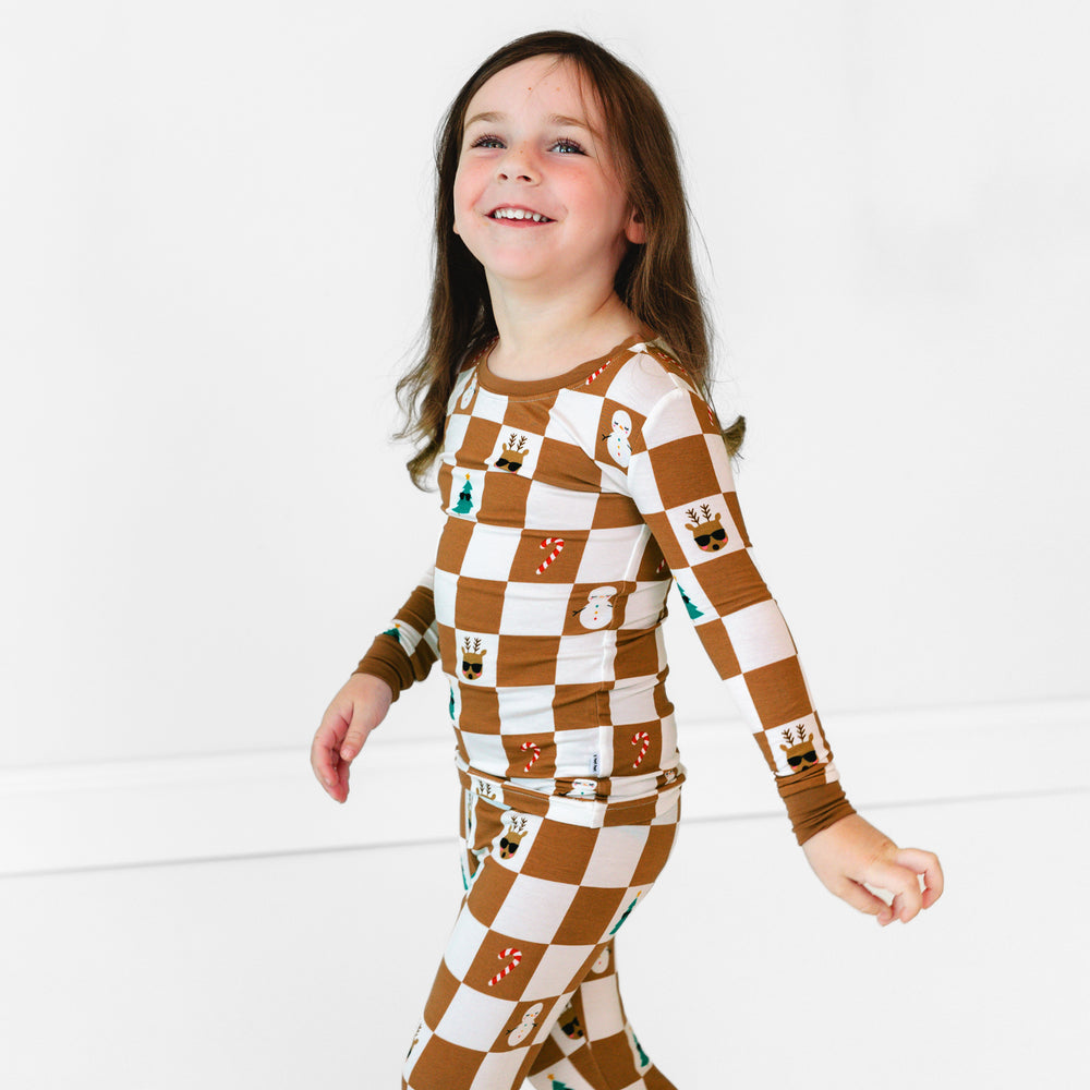 Side view image of girl walking while wearing the Holiday Checks Two-Piece Pajama Set