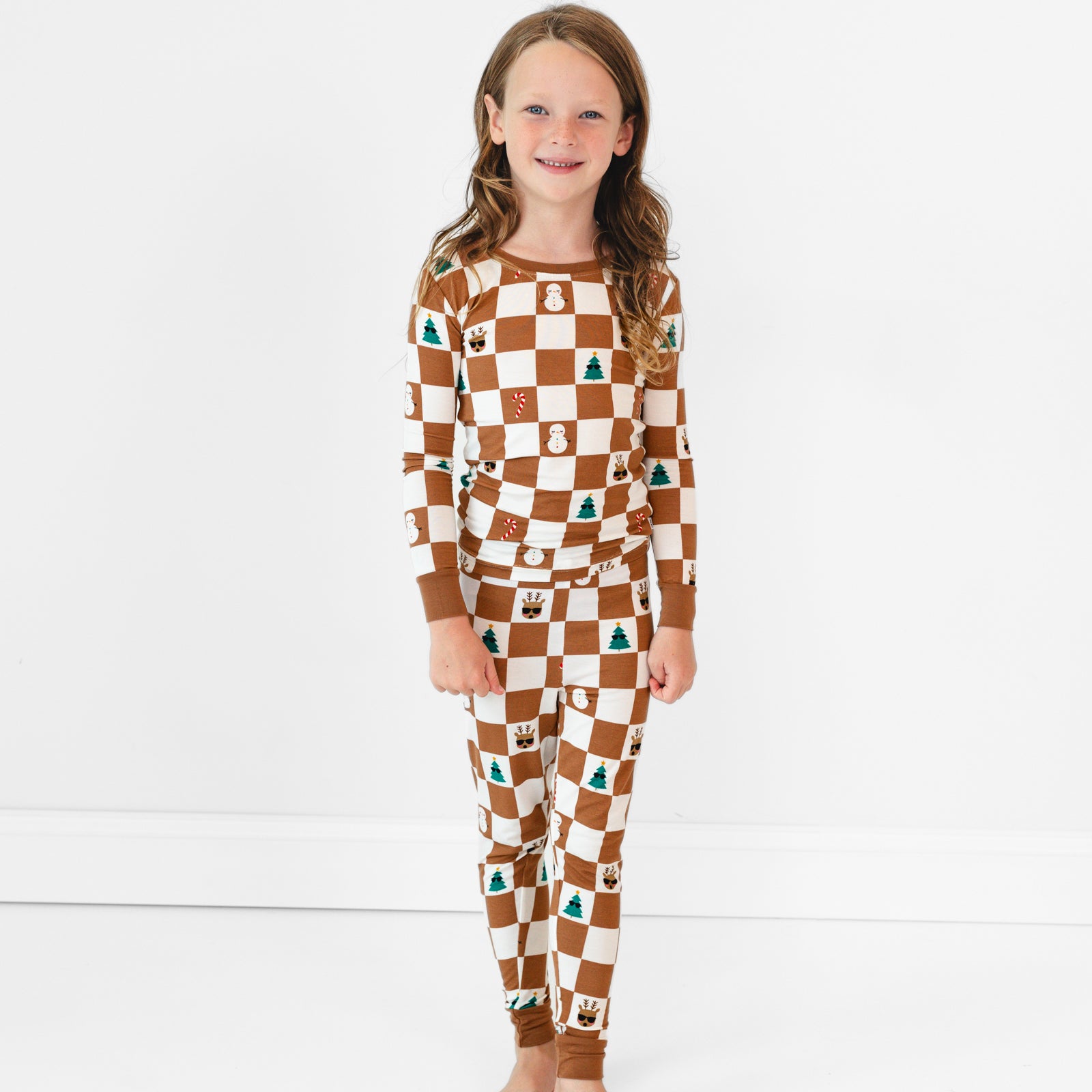 Smiling girl wearing the Holiday Checks Two-Piece Pajama Set