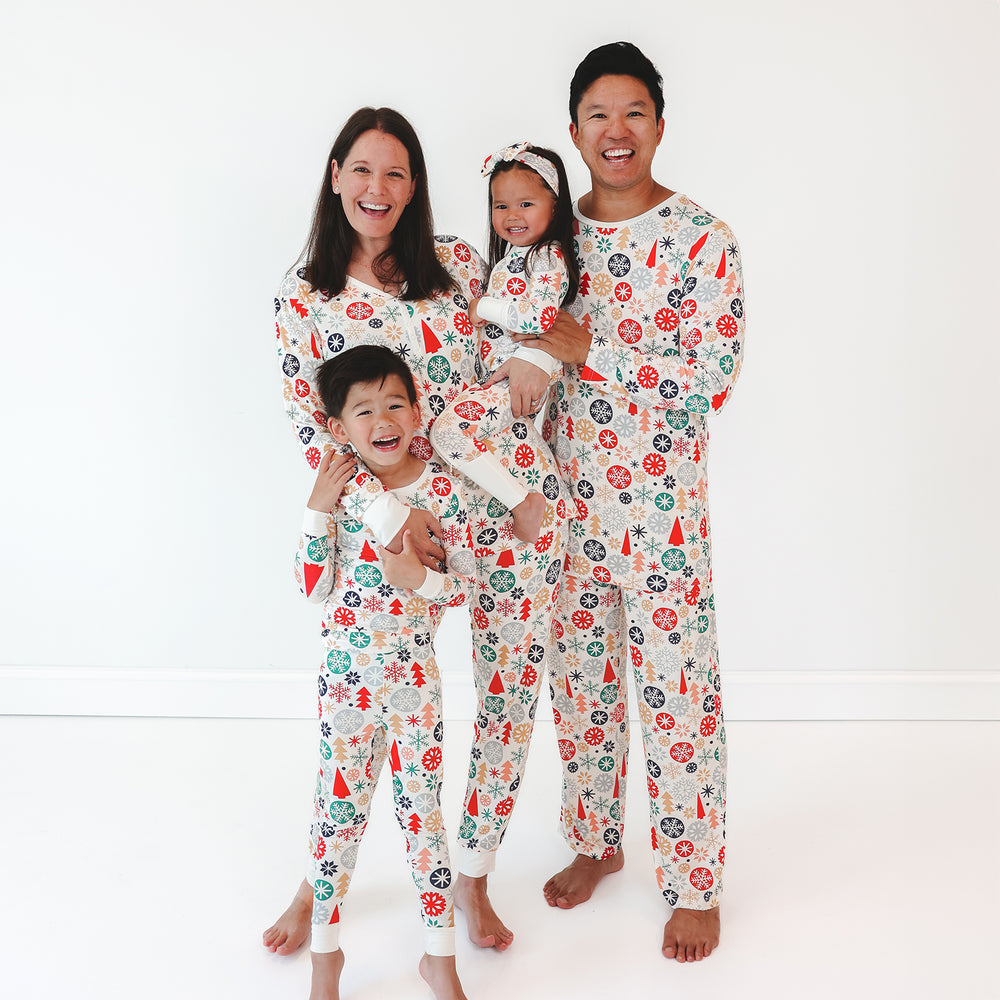 Image of a family of four wearing the Modern & Merry prin. ale model on the right is in the Modern & Merry Men's Pajama Pants and Top