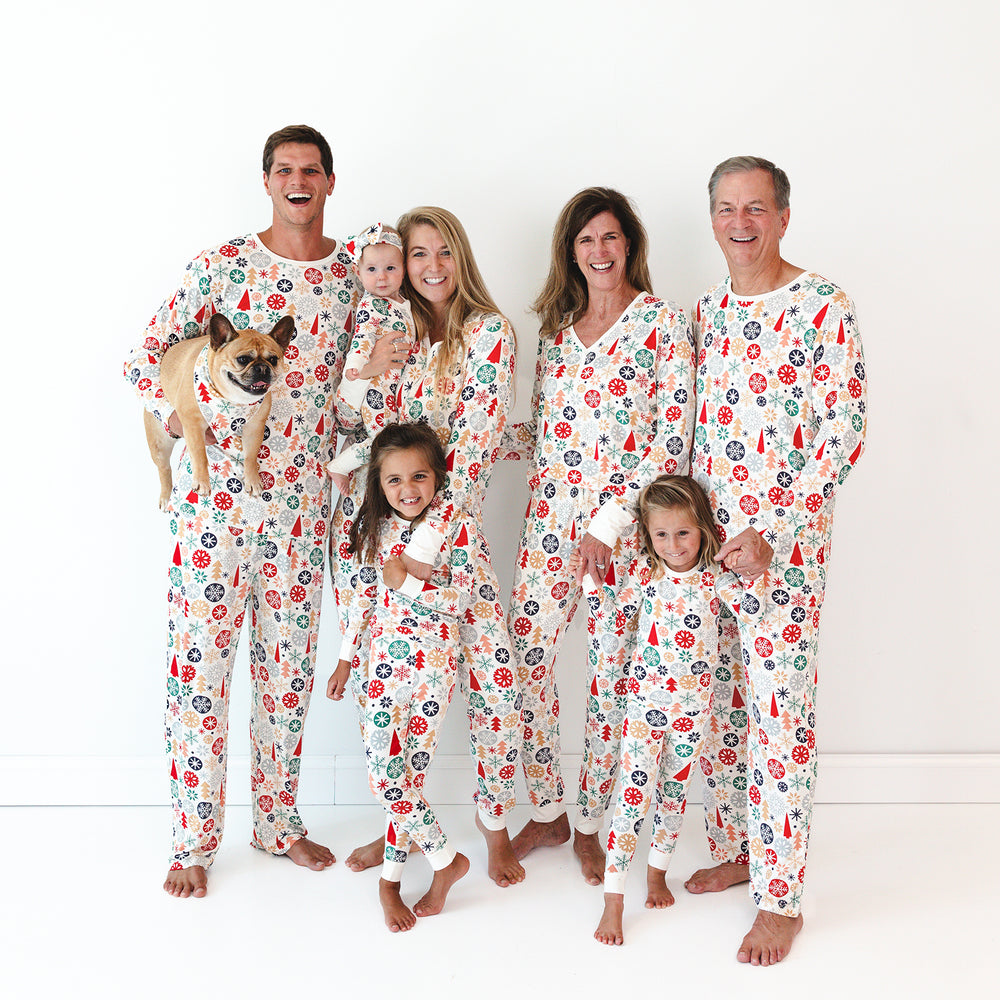 Image of a family of seven plus dog, all wearing the Modern & Merry print. The female models are wearing the Modern & Merry Women's Pajama Top and Modern & Merry Women's Pajama Pants