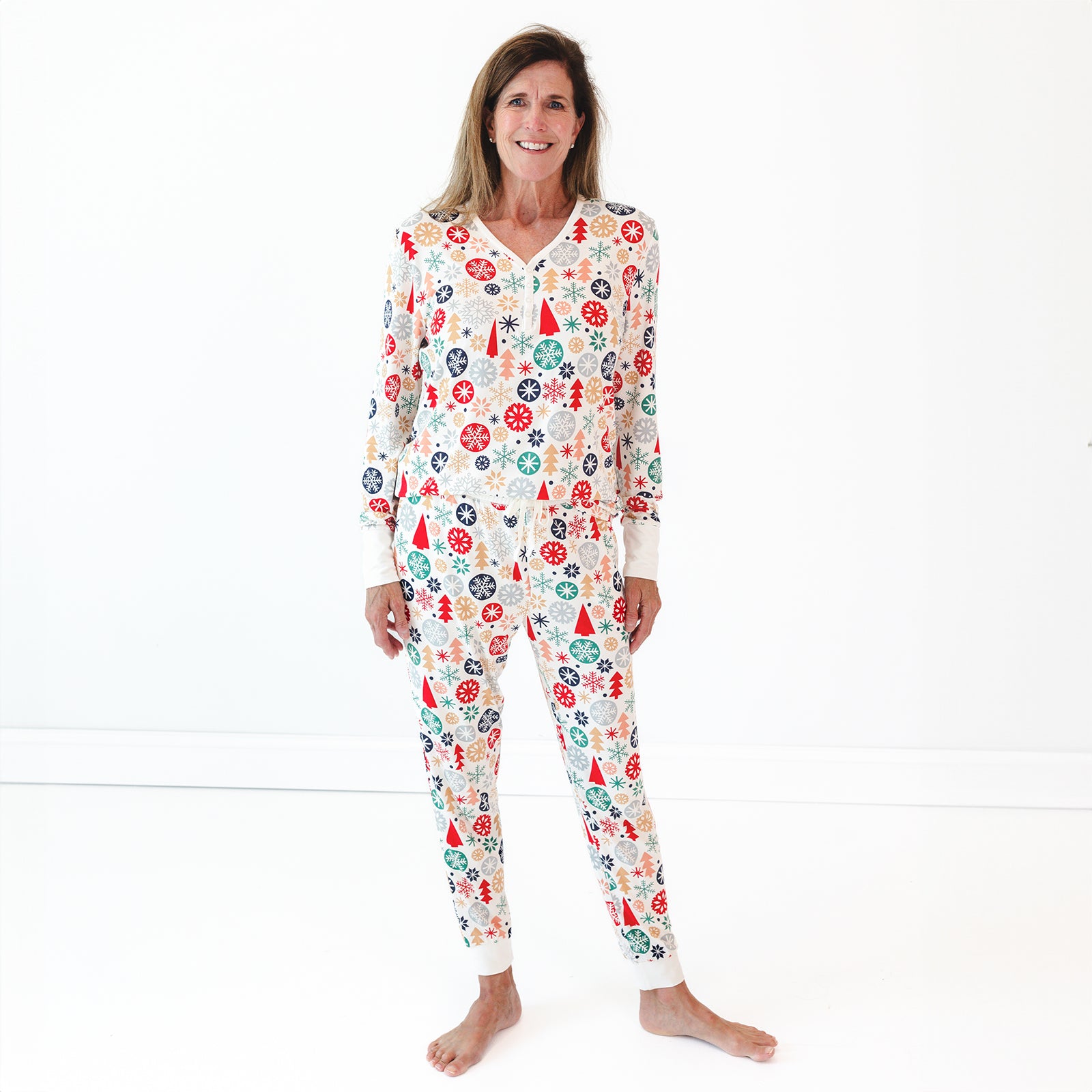 Smiling female model wearing the Modern & Merry Women's Pajama Pants and the Modern & Merry Women's Pajama Top