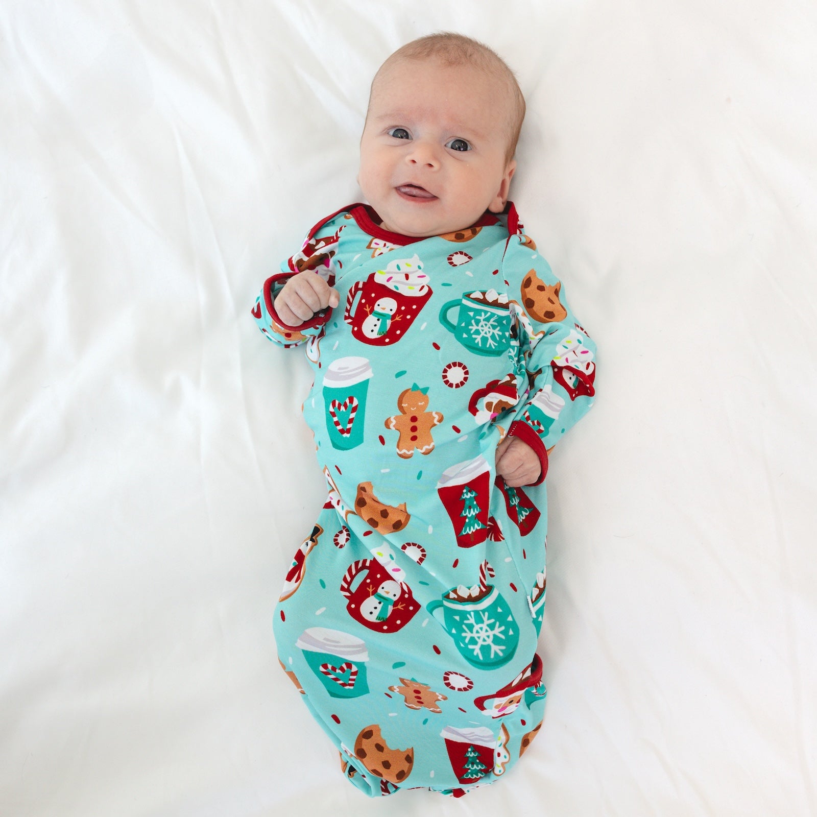 Image of an infant laying on a blanket in a Peppermint Mocha Infant Gown