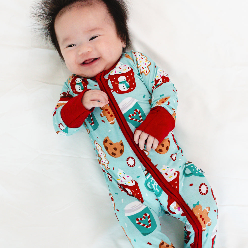 Child laying on a blanket wearing a Peppermint Mocha Zippy