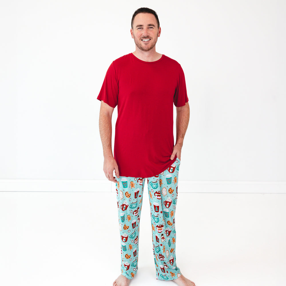 Smiling male model wears the Holiday Red Men's Short Sleeve Pajama Top and Peppermint Mocha Pajama Pants