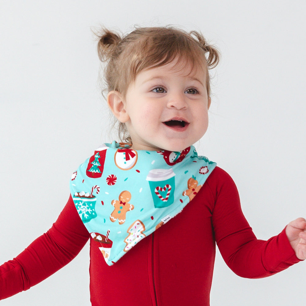 Image of a child wearing a Peppermint Mocha Bandana Bib and Holiday Red Zippy