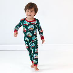 Smiling boy wearing the Disney A Very Pixar Christmas Two-Piece Pajama Set