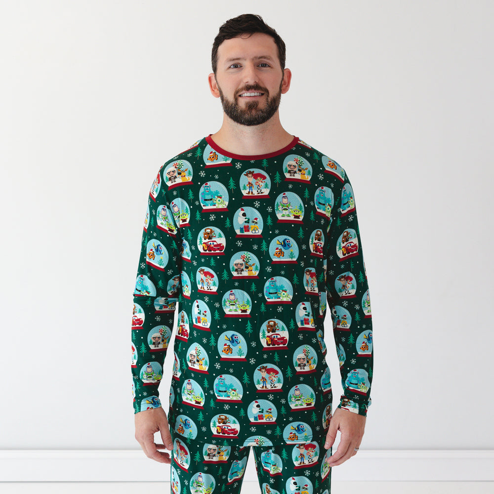 Close up image of smiling male model wearing the Disney A Very Pixar Christmas Men's Pajama Top