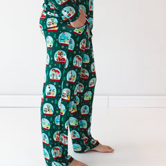 Close up side view image of male model wearing the Disney A Very Pixar Christmas Men's Pajama Pants while displaying the pockets